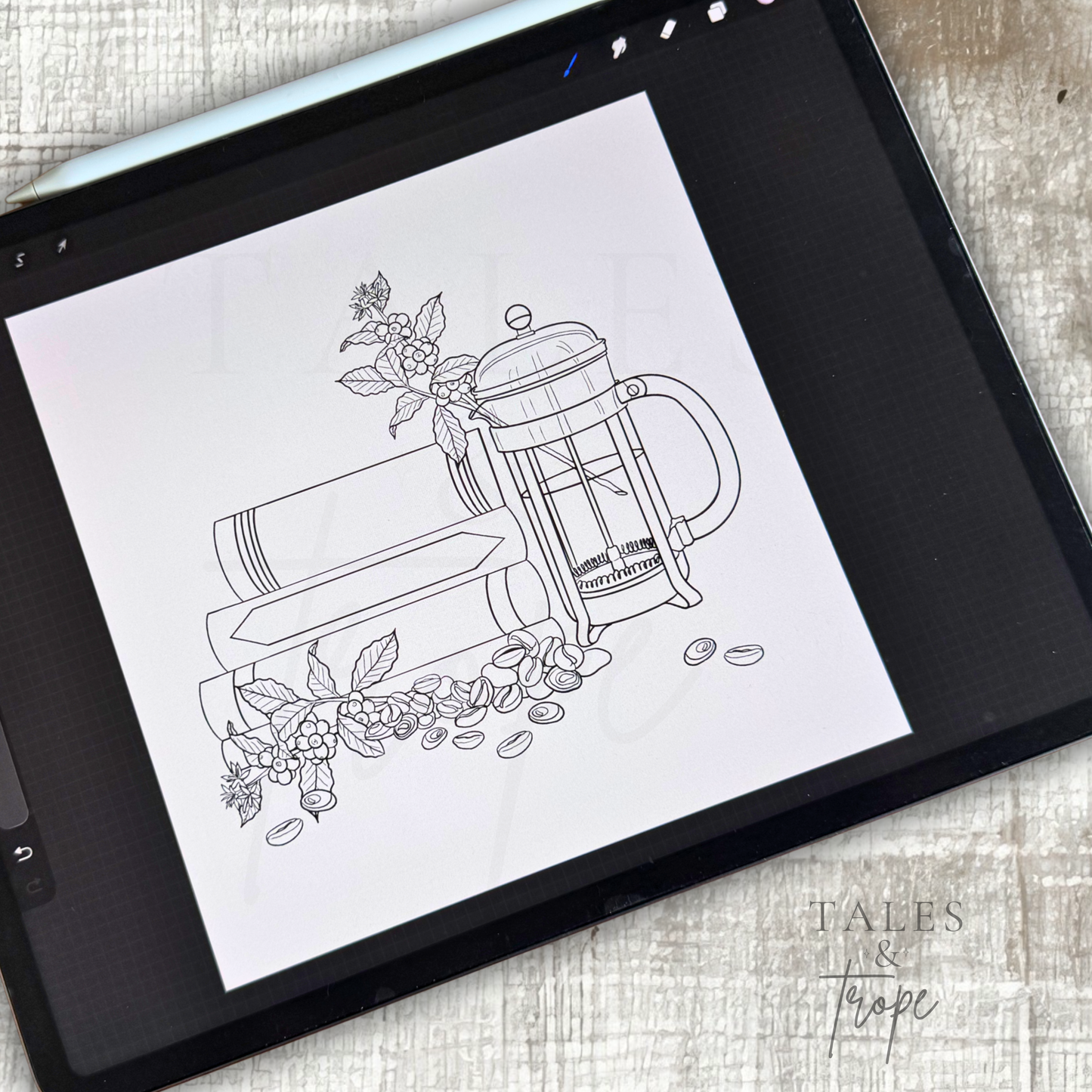 A black tablet lying on a light beige textured fabric surface, displaying a black-and-white line art illustration of stacked books, a French press, and coffee beans. The words 'Tales & Tape' appear in the lower right corner.