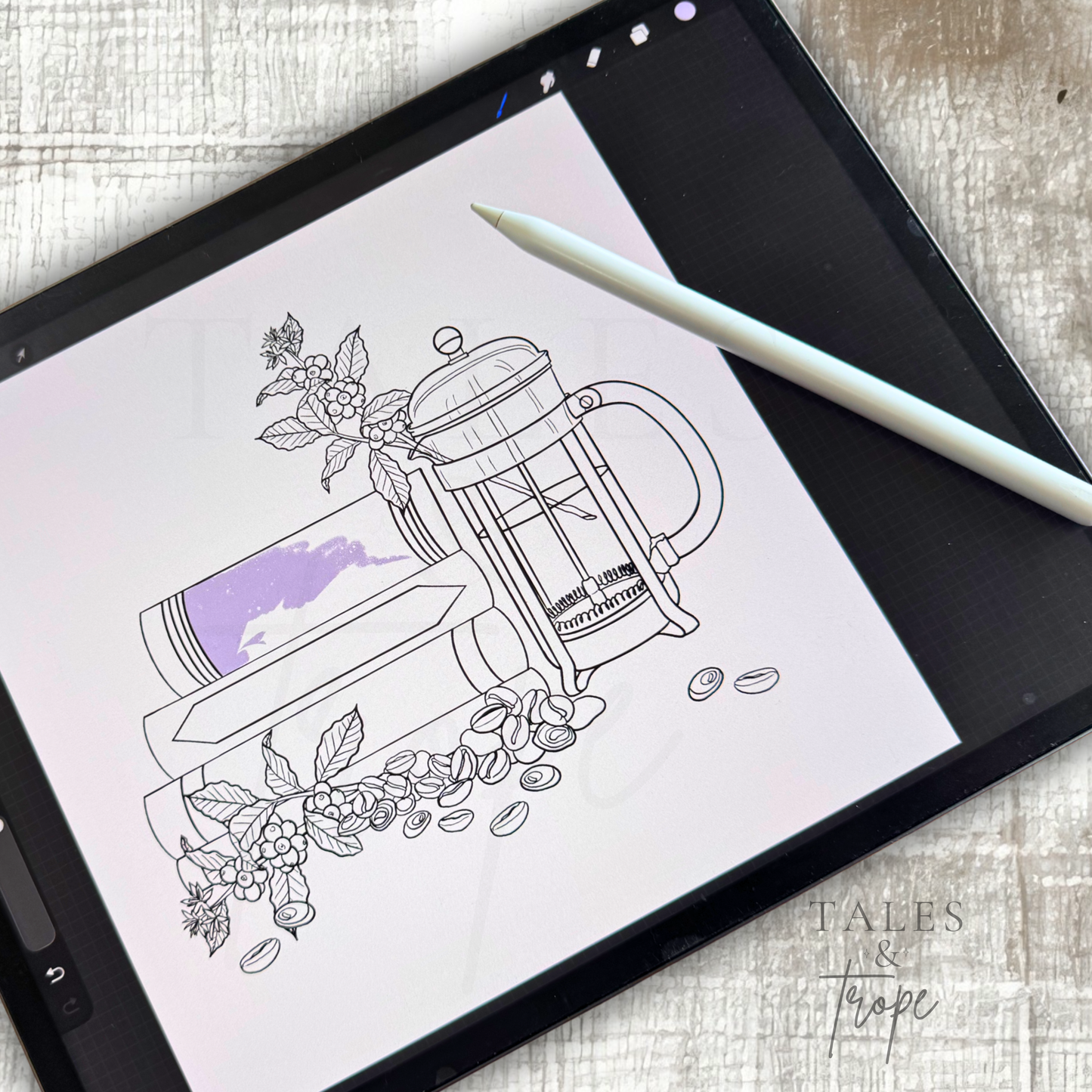 A tablet screen displays a black-and-white line art illustration of a French press coffee maker with flowers and coffee beans, with a light purple color swatch applied to the glass. A white stylus rests on the tablet, which is placed on a light wood surface.
